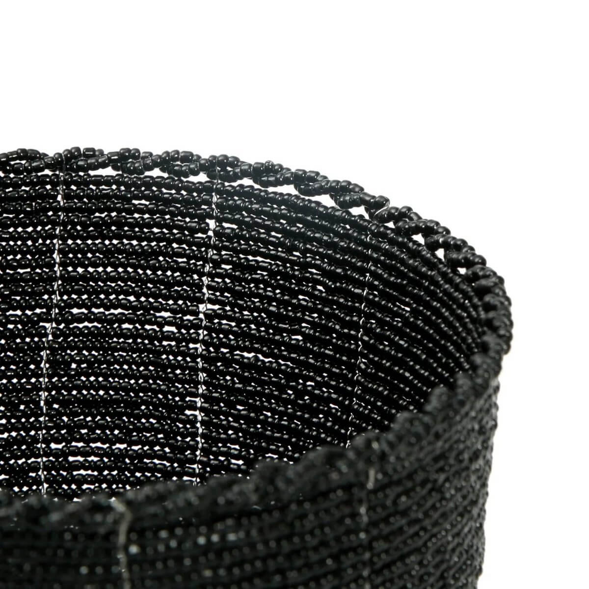 Close-up of black handmade beaded bowl, perfect for bohemian home decor.